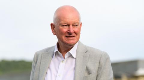 Steve Lansdown wearing a suit while at a Bristol Bears game
