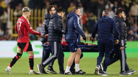 Manchester United winger Antony is consoled by team-mate Alejandro Garnacho as he is carried off on a stretcher during the Europa League draw with Fenerbahce