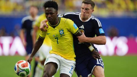 Lewis Ferguson of Scotland battles for the ball with Brazil's Vini Jr