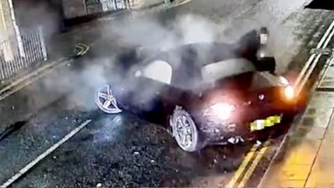 A BMW crashed into the side of a house