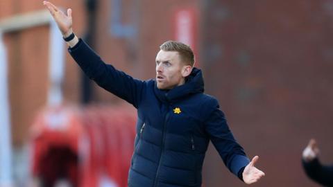 Ed Still on the touchline at a match, waving his arms