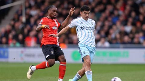 Morgan Gibbs-White of Nottingham Forest is tackled by Teden Mengi of Luton Town during the Premier League match between Luton Town and Nottingham Forest at Kenilworth Road