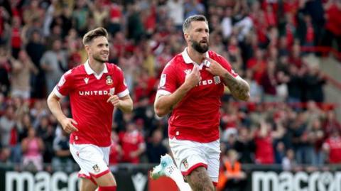 Ollie Palmer (right) celebrates after scoring Wrexham's opening goal in the 3-0 win over Shrewsbury Town