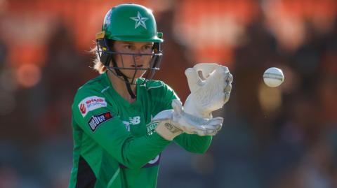 Amy Jones catches the ball while wicketkeeper for Melbourne Stars in the Big Bash League