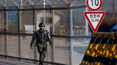 File photo of a South Korean soldier patrolling at a checkpoint leading to the demilitarised zone separating the Koreas