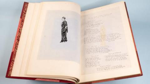 An open book showing a sketch of a person and notes on the opposite page