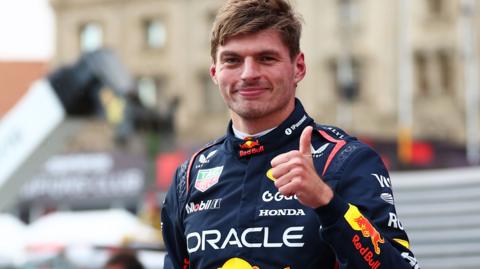 Max Verstappen puts his thumb up in celebration after taking pole for the Azerbaijan Grand Prix