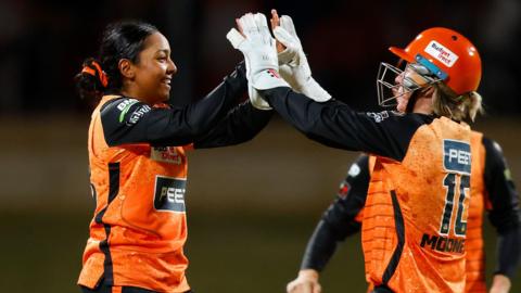 Perth Scorchers' Alana King celebrates a wicket with Beth Mooney