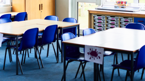 Empty chairs in a classroom.