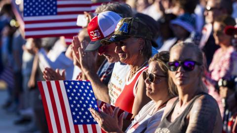 Visitors attend the opening concert of the Freedom 250 Great American State Fair on the National Mall in Washington DC.