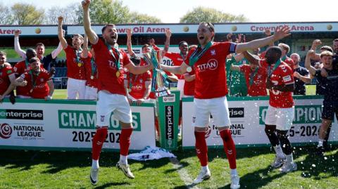 York City players celebrate while lifting the National League trophy