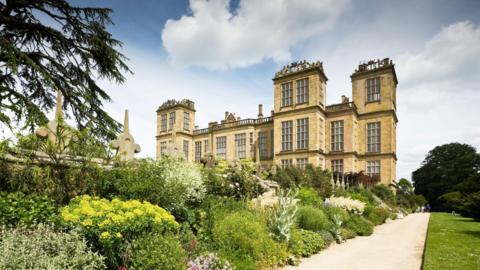 Hardwick Hall a grand and historic stone building with floral garden in front