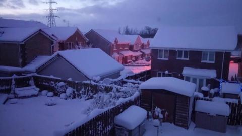 Snow-covered houses on a residential street in Lanarkshire 