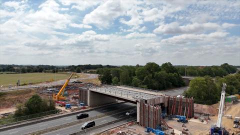 drone footage of construction work on a bridge over a dual carriageway