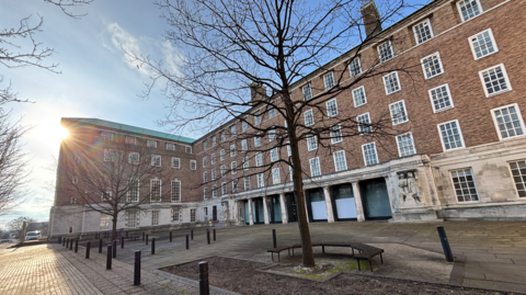 County Hall in Nottinghamshire, a five-storey red-brick building with trees in the foreground