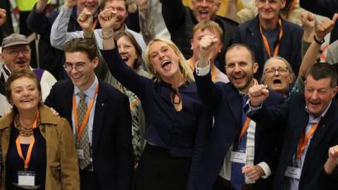 SNP politicians celebrating at a by-election count
