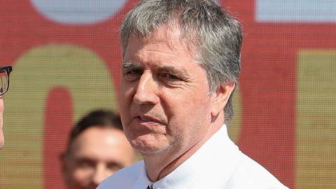 Steve Rotheram with greying hair and a white T-shirt at Andy Burnham's by-election campaign launch.