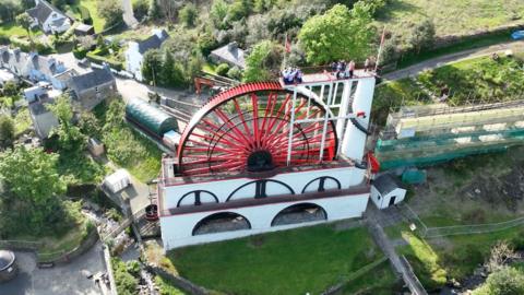 The choristers singing atop the Laxey Wheel 