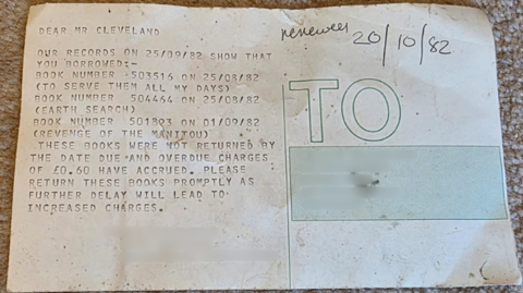 A picture of a letter which is detailing a number of library book fines.
