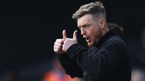 Kim Hellberg gives a double thumbs up on the Boro sideline