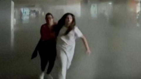 People run from earthquake hit building 