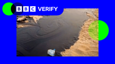 A slick of oil flowing on a beach