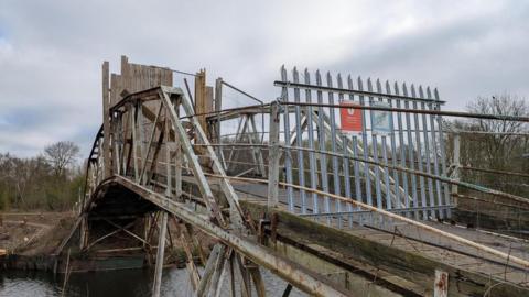 An old bridge at Attenborough Nature Reserve which has been sealed off with a metal fence 