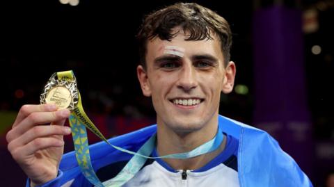 Gold medalist Reese Lynch of Team Scotland celebrates during the Men's Boxing Over 60kg-63.5kg (Light Welterweight) medal ceremony on day ten of the Birmingham 2022 Commonwealth Games at NEC Arena on August 07, 2022 on the Birmingham, England