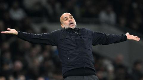 Pep Guardiola with his arms held out in a questioning gesture
