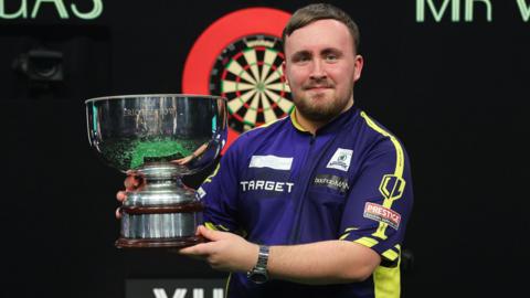 Luke Littler celebrates winning the Grand Slam of Darts in Wolverhampton