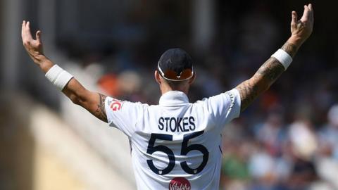 Ben Stokes raises his arms to celebrate a wicket 