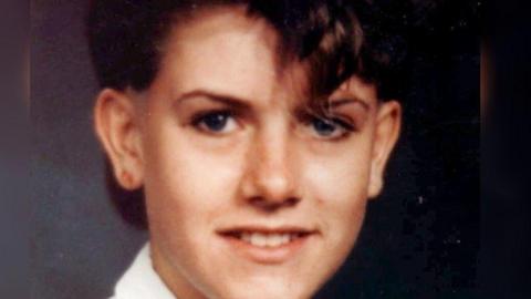 A school portrait of Lisa Hession, she has short brown hair and is smiling.