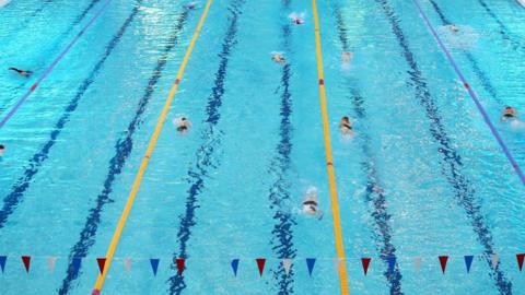 Swimmers in action at a swimming pool