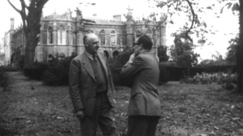 Alan Whicker interviewing Cecil Williamson in front of an old manor building