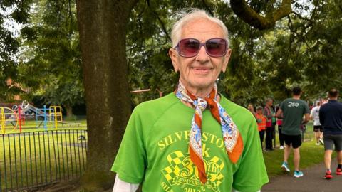 Bob Emmerson wearing a  green T-shirt, which has Silverston 10k 30th anniversary written on it in yellow letters. 