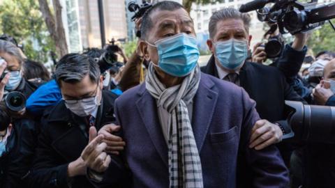 Jimmy Lai wearing a face mask arrives in court in Hong Kong