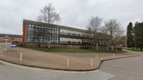 Banchory Academy school building, with trees outside.