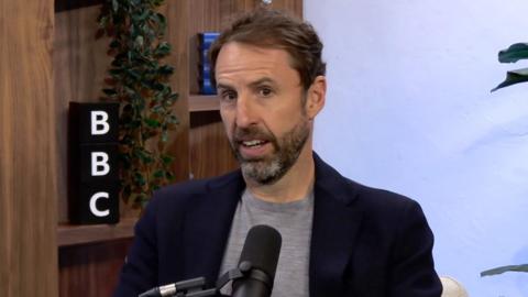 Gareth Southgate wears a t-shirt and blazer as he sits in a BBC podcast studio