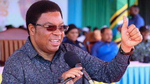 A close up of Kassim Majaliwa wearing glasses and a floral shirt 