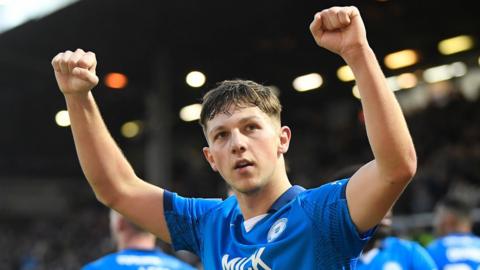 Harry Leonard, with both fists raised, celebrates a victory for Peterborough United
