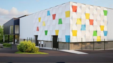 An computer generated image of how the new centre would look with yellow, green and blue squares on the walls in a sea of white. It would be a large rectangular two-story building.
