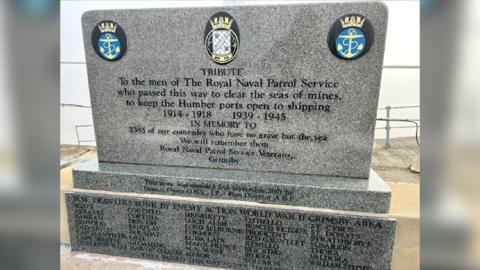 A rectangular, free standing memorial, which states: To the men of The Royal Naval Patrol Service who passed this way to clear the seas of mines, to keep the Humber ports open to shipping 1914 - 1918, 1939 - 1945.
At the foot of the memorial is a list of trawlers sunk during World World Two.