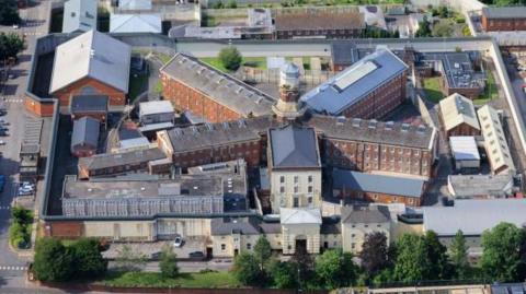 An aerial photo of the prison. It's a square complex with buildings arranged in a star shape around a central tower.