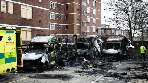 Burnt out ambulances are pictured at the scene of an antisemitic arson attack in the Golders Green