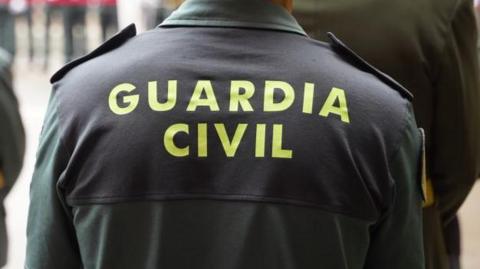 A Spanish police uniform that says, Guarda Civil on the back.