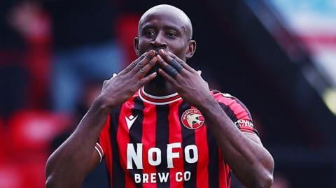 Albert Adomah salutes the crowd at Walsall's Bescot Stadium