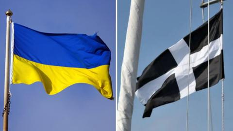 A Ukraine flag and a St Piran flag.