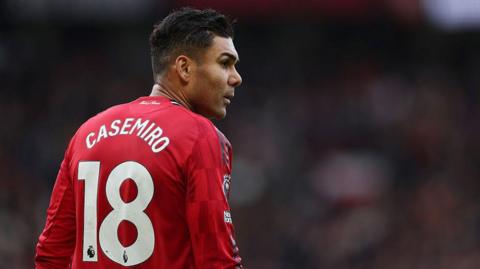 Image of the back of Casermiro during match as he looks on sideways