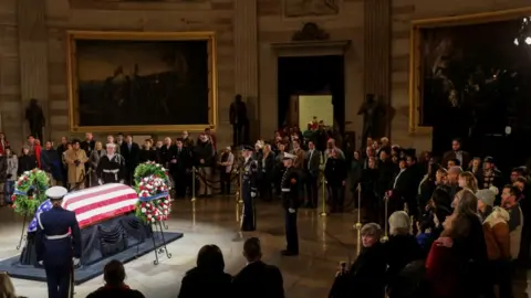 Members of the public surround Jimmy Carter's casket at the US Capitol