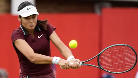 Emma Raducanu hits a shot